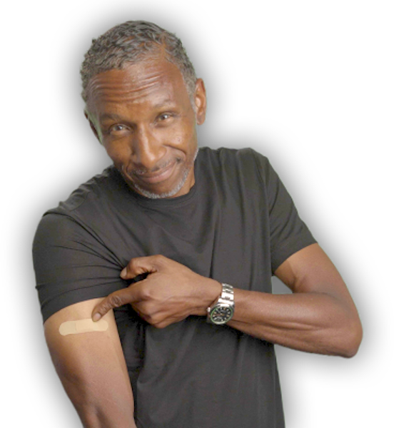 Dres from Black Sheep pointing at where he got his vaccine