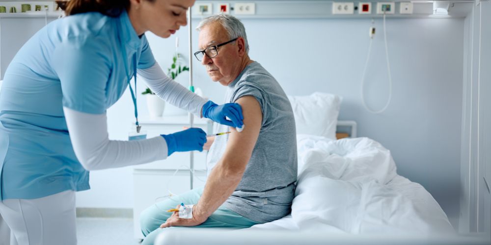 Older man receiving vaccination shot