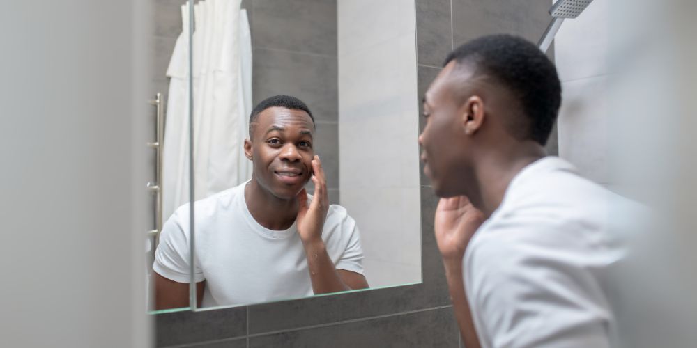 Man checking his skin in the mirror