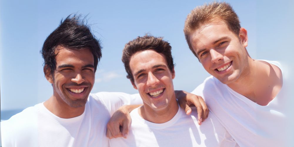 Three guys wearing white t-shirts