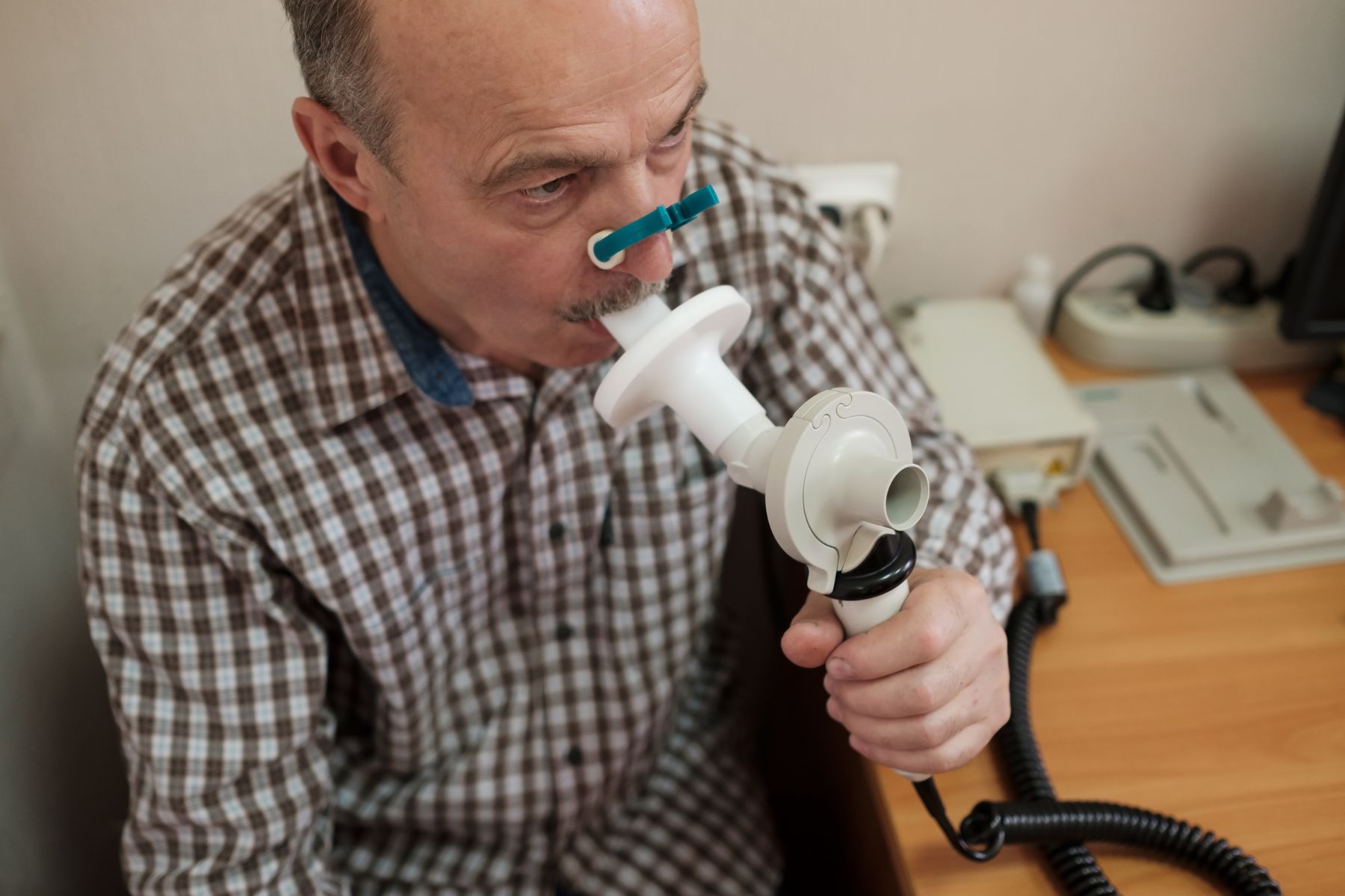 Hispanic man with spirometer. 